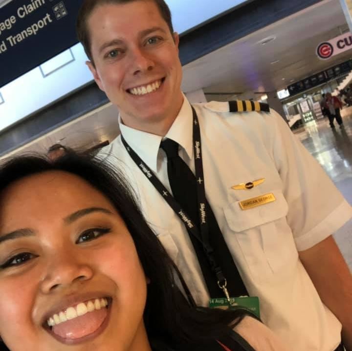 Male pilot and female flight attendant smiling