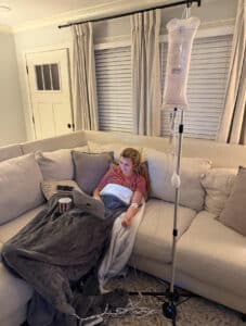 Woman on couch getting an IV