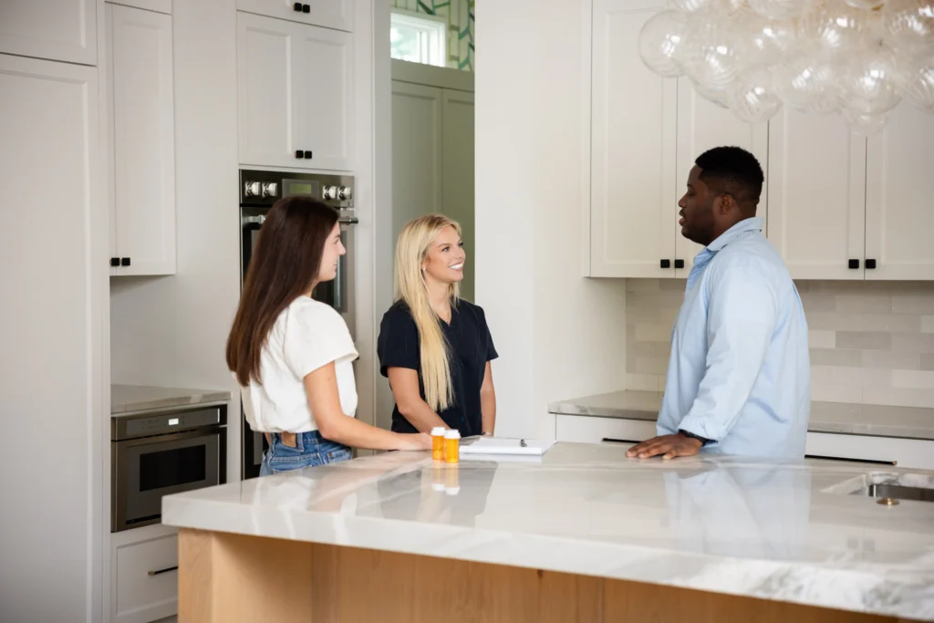 three people talking in an office